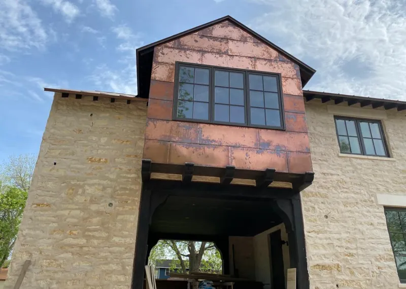 Copper metal panel facade on a stone building for Skylight Installation in Laketon