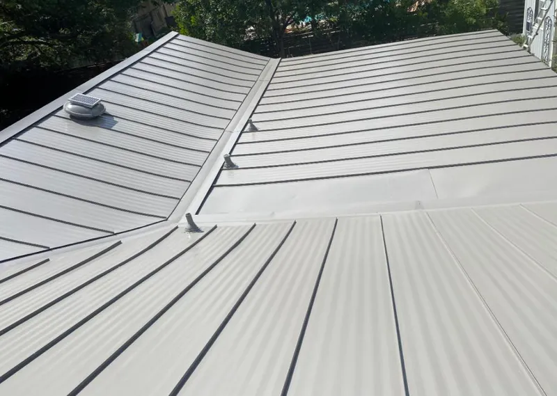 Solar attic fan installed on a metal roof for Roof Ventilation in Laketon